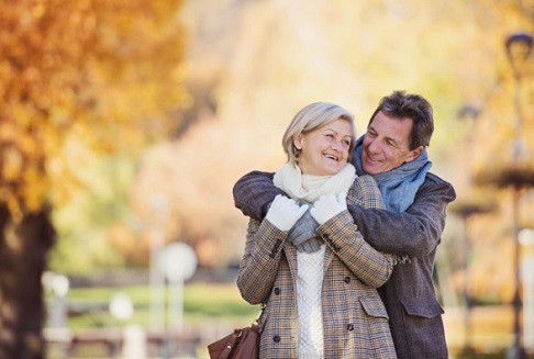 Beautiful  active seniors on a walk in a town park
